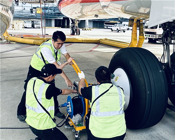 Aircraft ground support technicians servicing landing gear